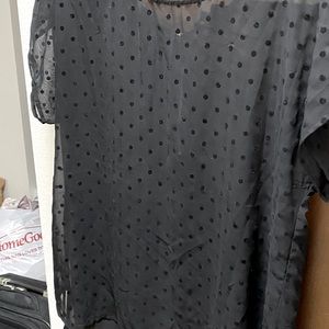 Sheer top with Swiss dots, zipper in back.